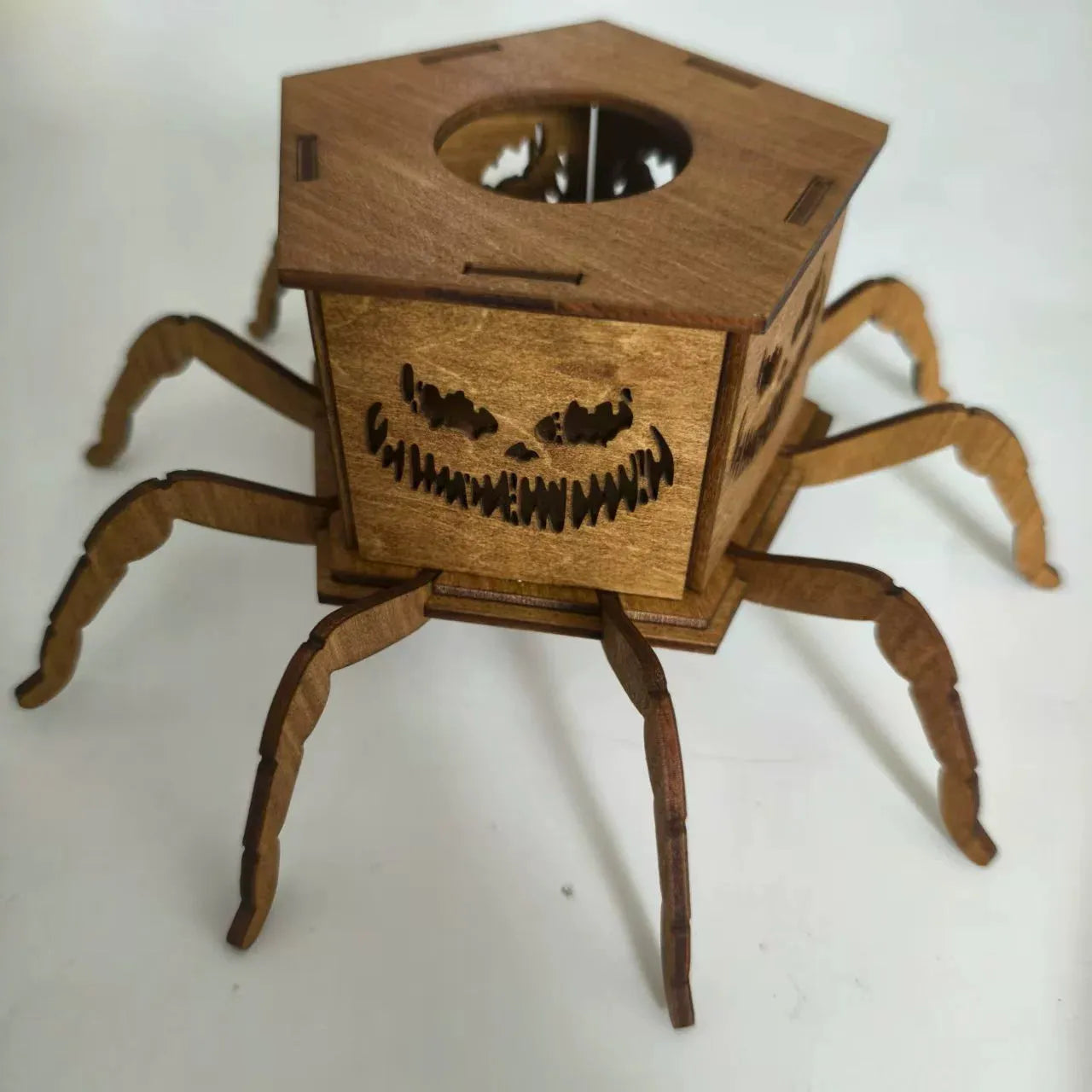 Wooden spider-shaped mini lantern candlestick Halloween decoration on a table