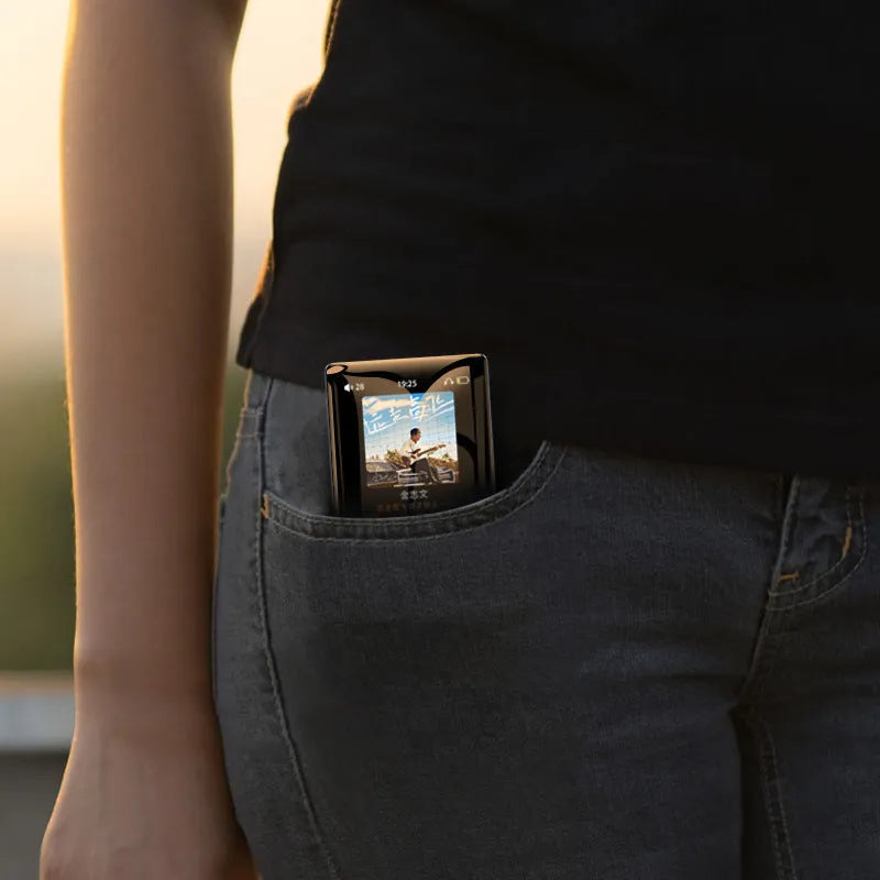 Black portable music player with 2.4-inch screen and touch buttons, featuring Bluetooth, FM radio, and e-book functions