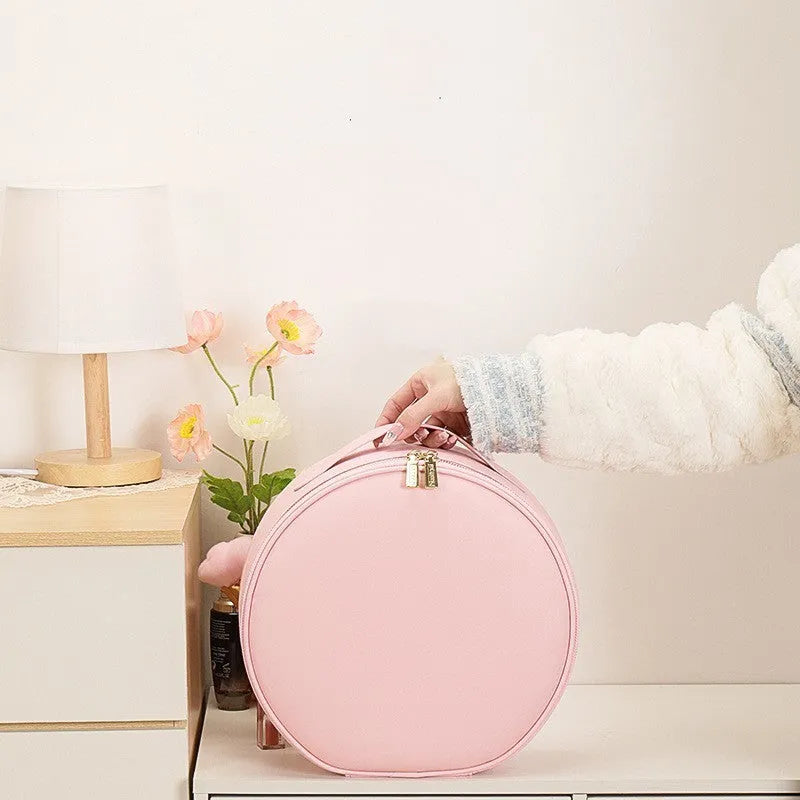 Round smart LED makeup bag with integrated mirror lights in cherry blossom pink colour with lattice partitions visible