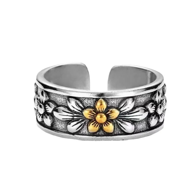 Vintage antique silver gold flower open ring with adjustable band and floral camellia motif on light background