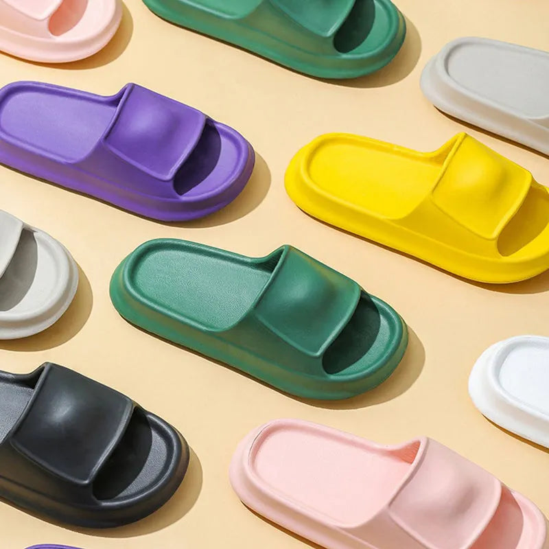Pair of thick-soled EVA flip-flop slippers in a choice of seven colours, shown on a wet bathroom floor.