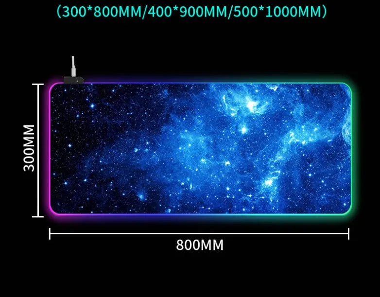 Starry sky pattern RGB luminous gaming mouse pad with USB cable on a desk