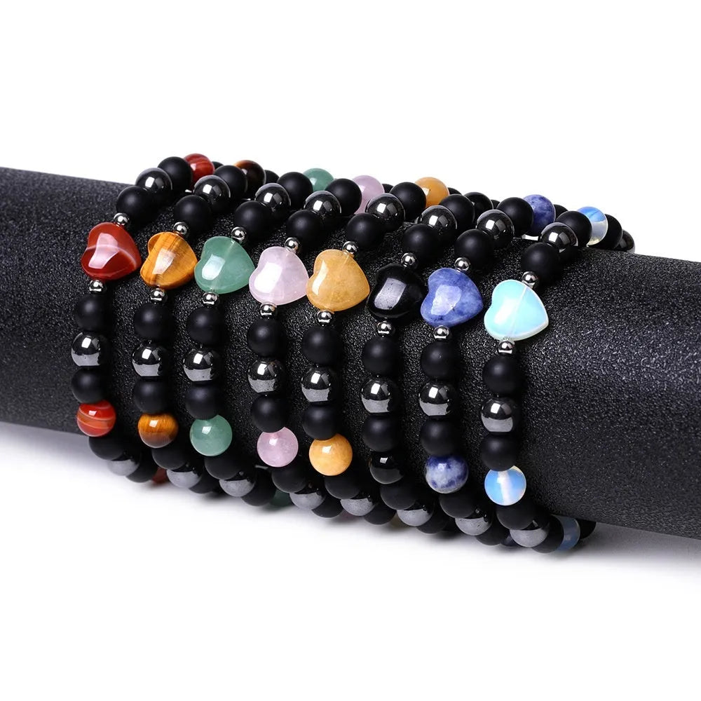 Hand-cut peach heart stone bracelet with geometric universe and moon design in various colours.