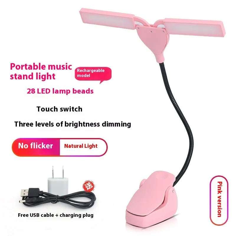 Black rechargeable music stand lamp with 28 LEDs and USB cable on a music stand.
