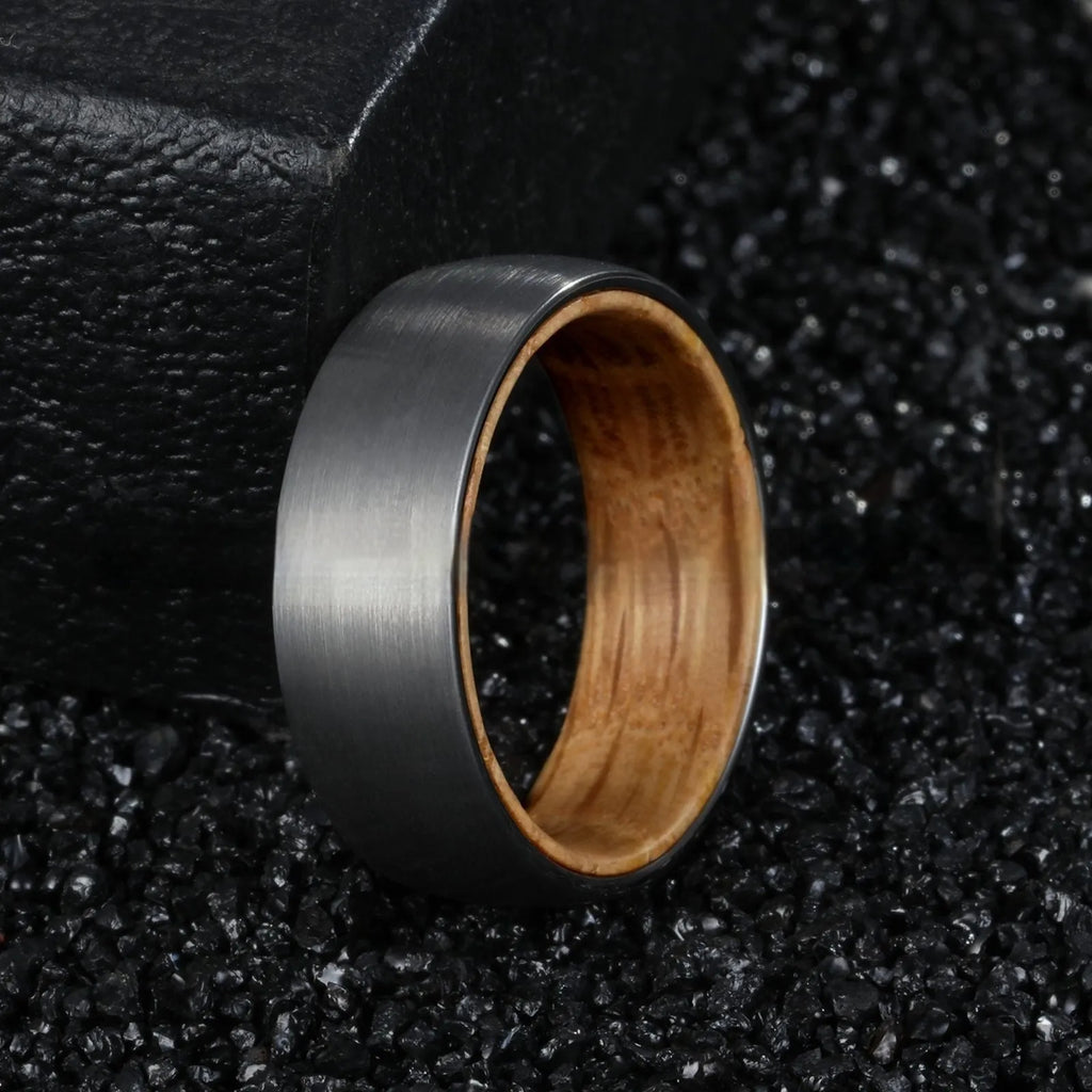 Silver tungsten ring with barrel wood inlay for men, simple band on light background