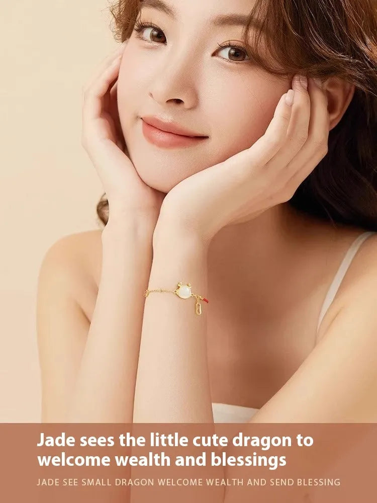 Silver-plated copper bracelet with a dragon zodiac pendant on a wrist.