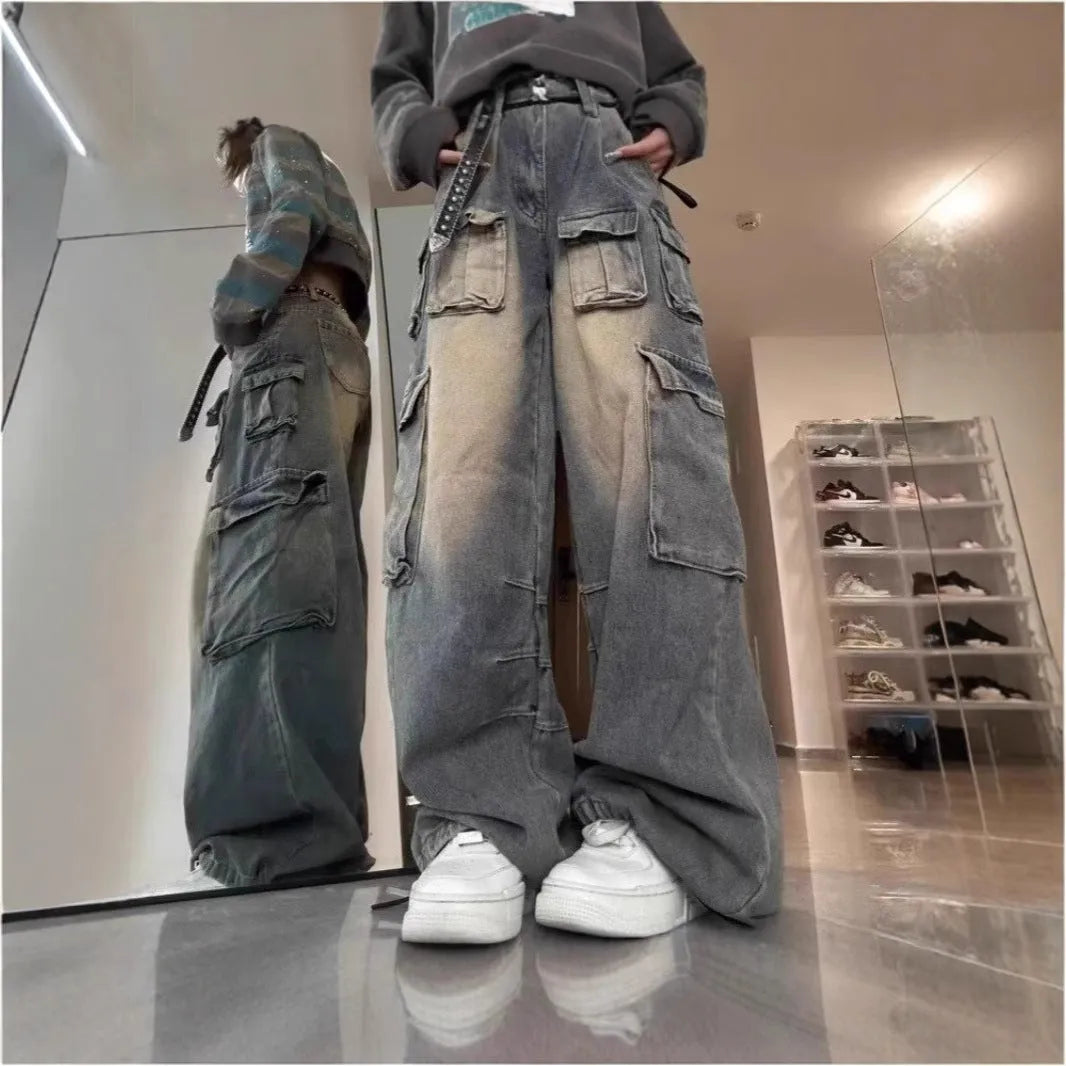 Loose-fit distressed denim pants with multiple pockets in light blue wash, straight-leg street style