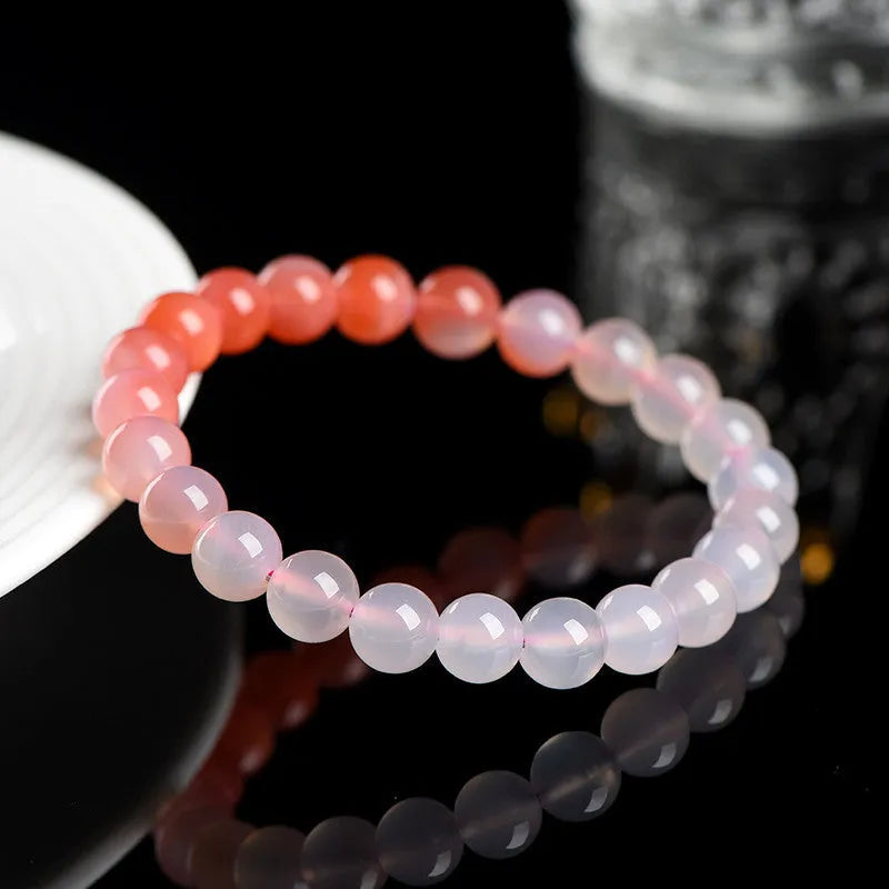 Natural gradient Yanyuan agate bracelet with geometric beads on a wrist, showing colour transition.