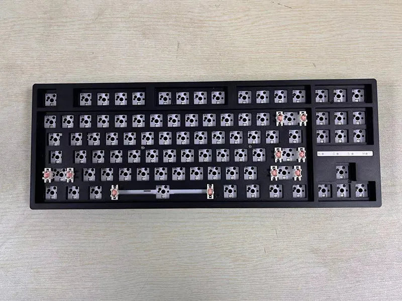 DIY mechanical keyboard kit with transparent case showing internal components and key puller tool