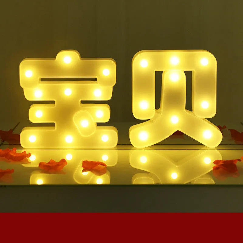 Plastic LED letter light decoration spelling a message, 22cm in height.