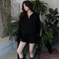 Ladies cream knitted jumper and shorts set with geometric pattern, shown on a hanger.