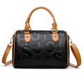 Brown cylindrical PU crossbody bag with a leather-like texture and three shoulder straps.