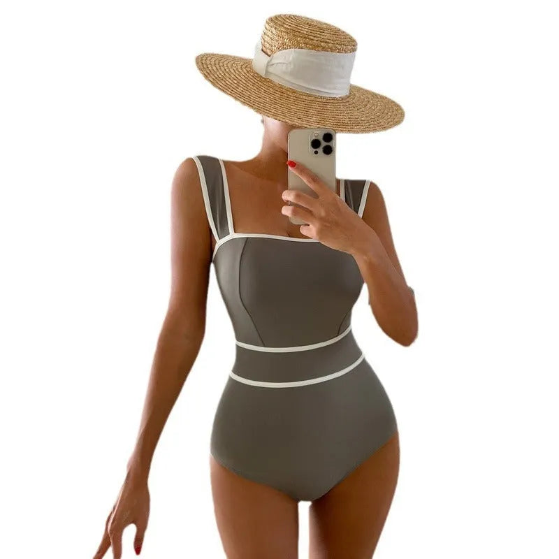 Women's white one-piece swimsuit with lace-up back design on mannequin