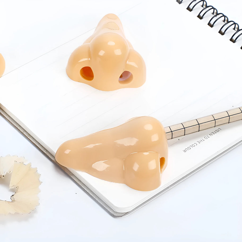 Flesh coloured plastic manual pencil sharpener with geometry shape and large nostril opening