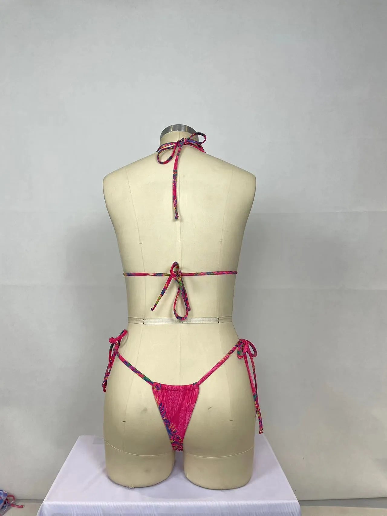 Pink printed women's two-piece bikini swimsuit with brief styling and backless design