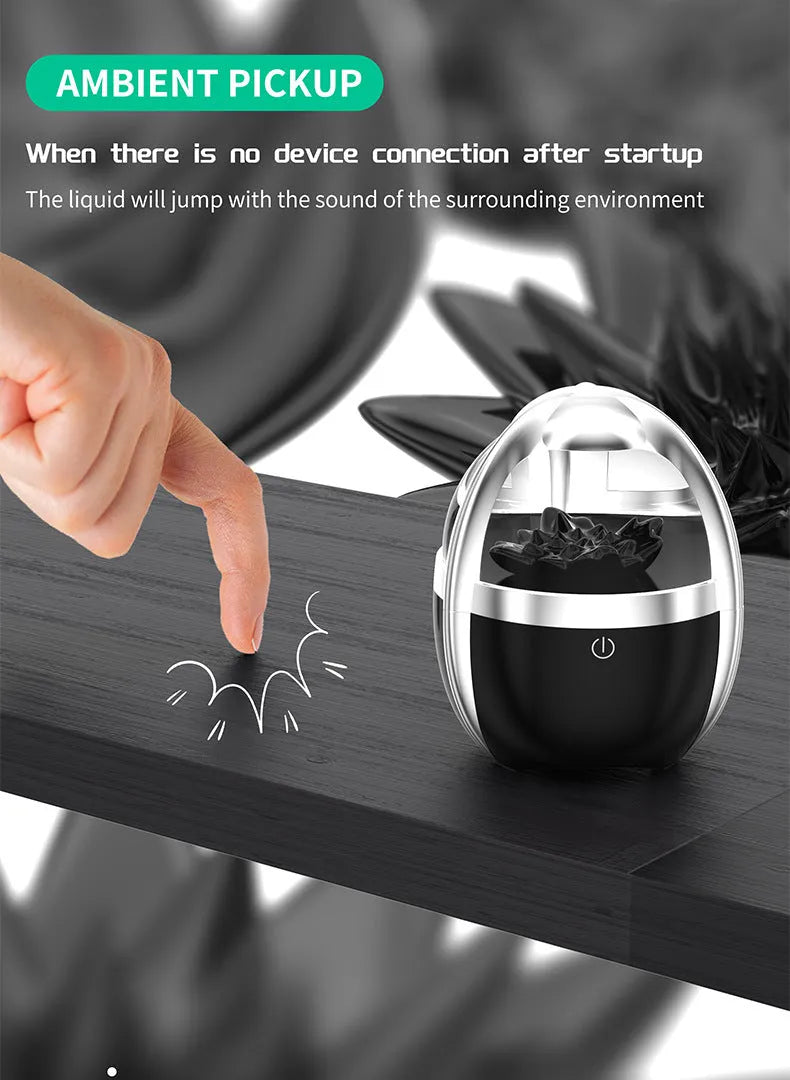 Magnetic fluid Bluetooth speaker in silver black with transparent glass and solid wood bracket
