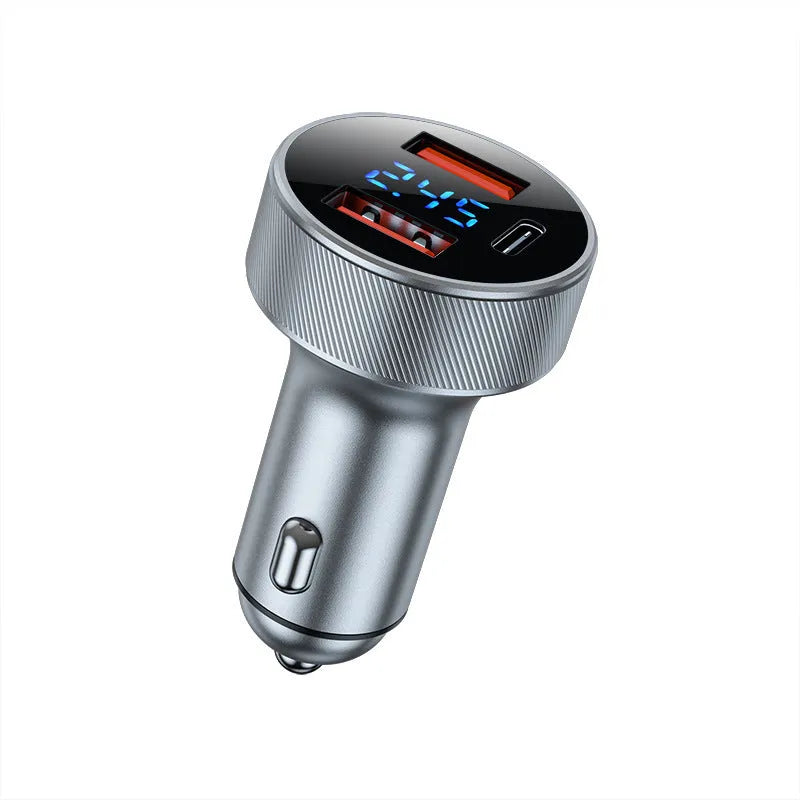 Black and iron grey aluminium alloy car charger with digital display plugged into a vehicle cigarette lighter