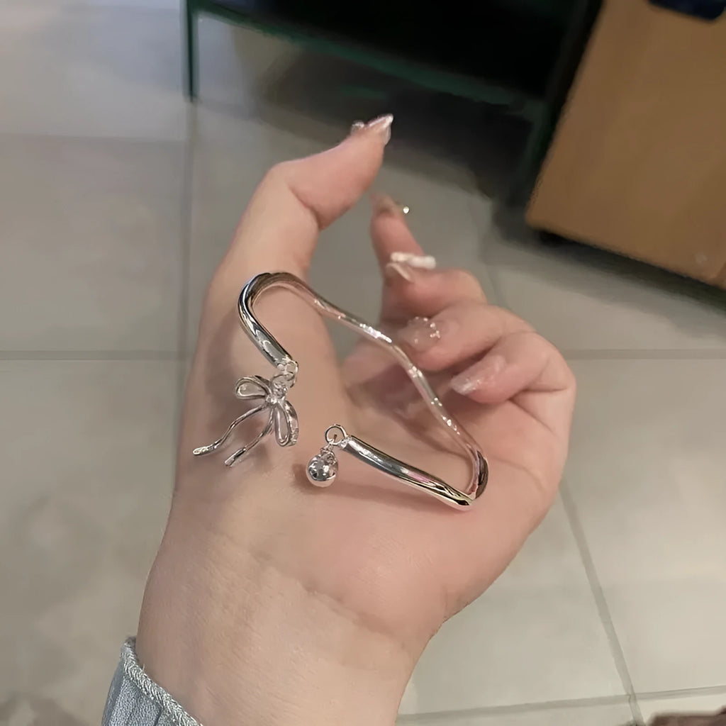 Silver adjustable girlfriends bracelet with bow-shaped bell opening clasp