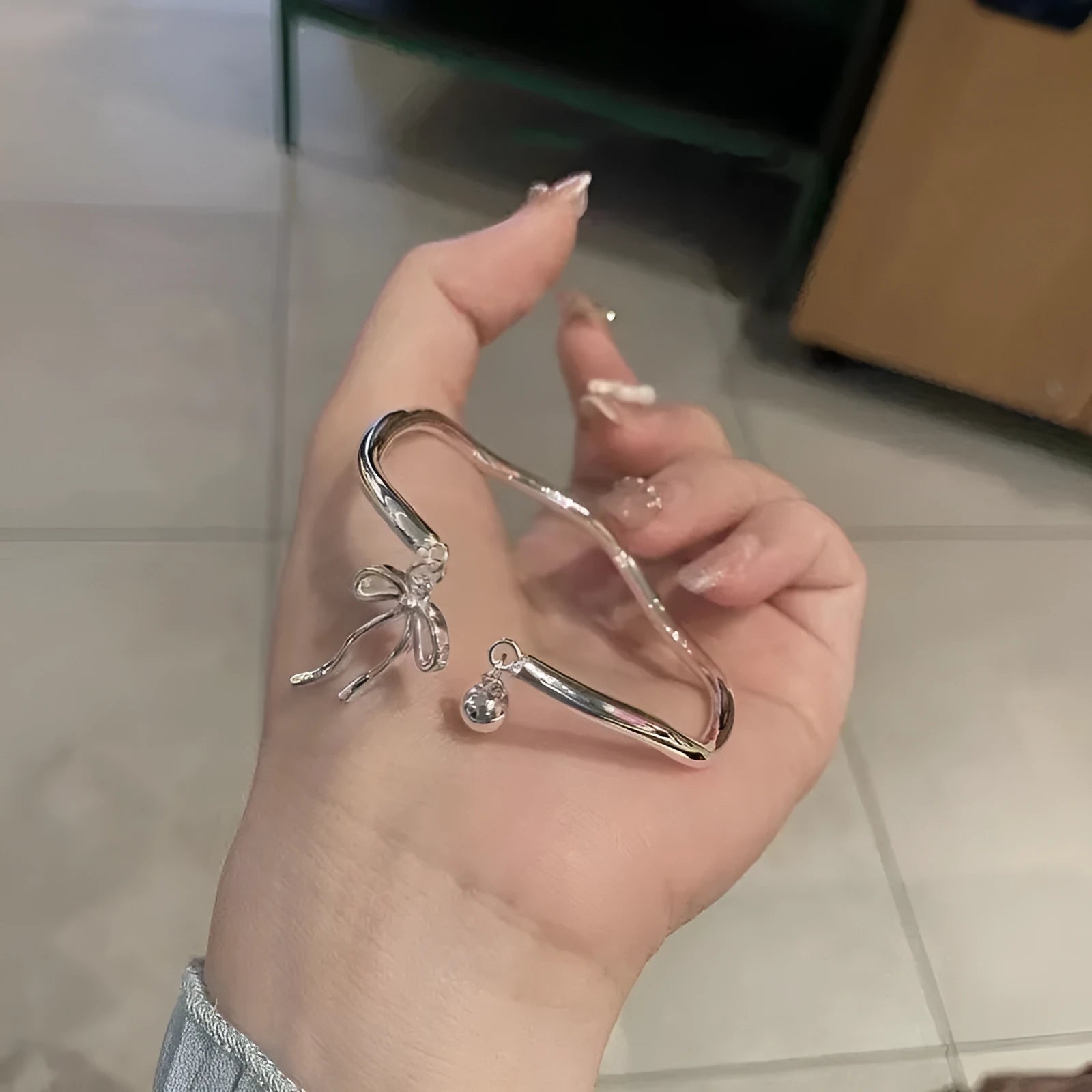 Silver adjustable girlfriends bracelet with bow-shaped bell opening clasp