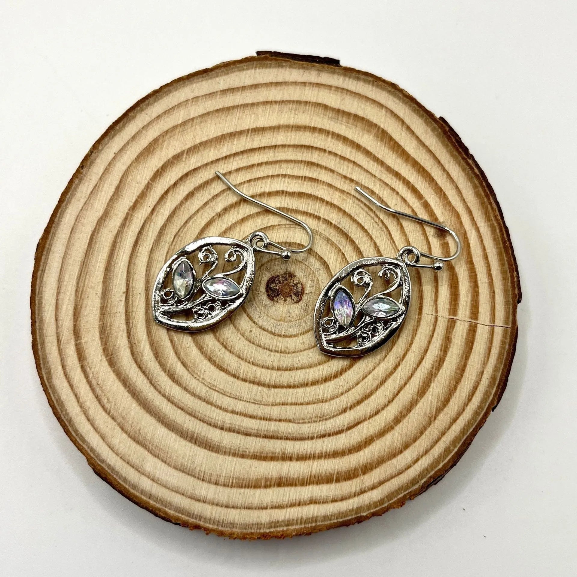 Silver leaf-shaped earrings with colourful embedded moonstone pieces and diamond treatment