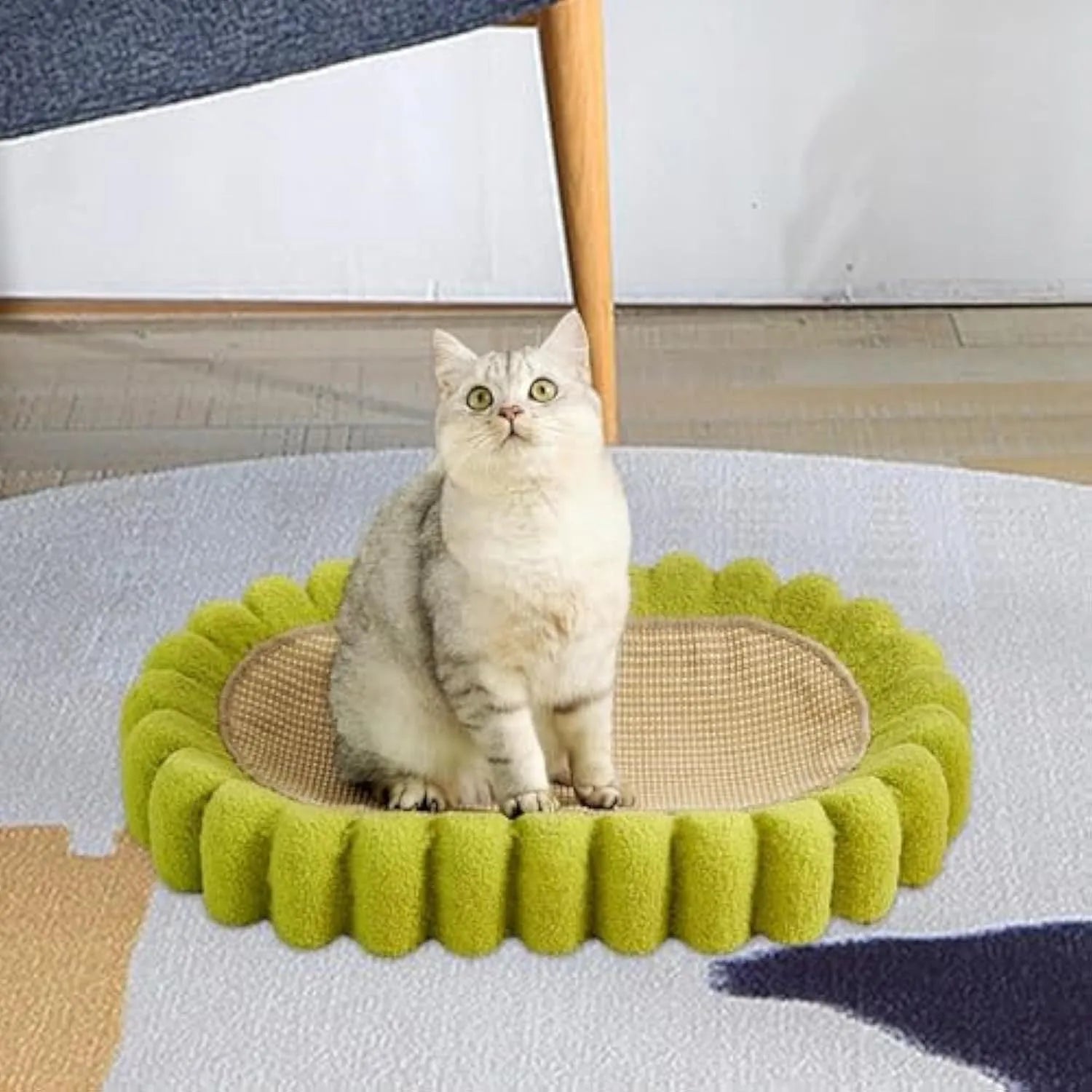 Green oval cat scratcher bed made of sisal, showing scratching surface and lounging area.