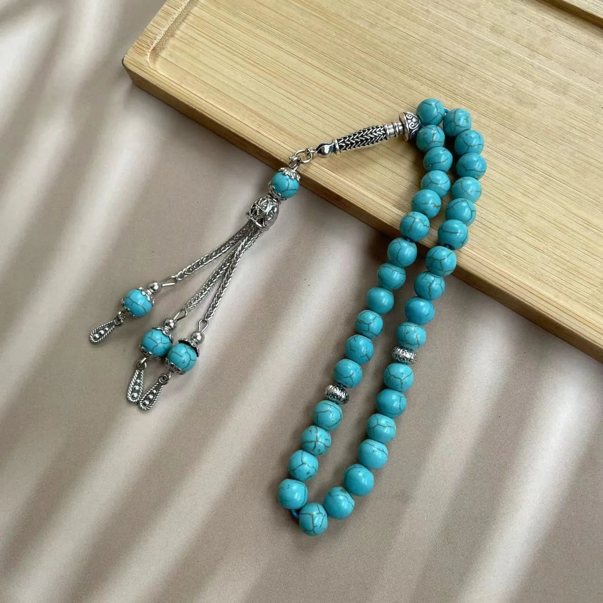 Handmade sky blue stone bead Muslim worship bracelet with 8mm beads on a white background