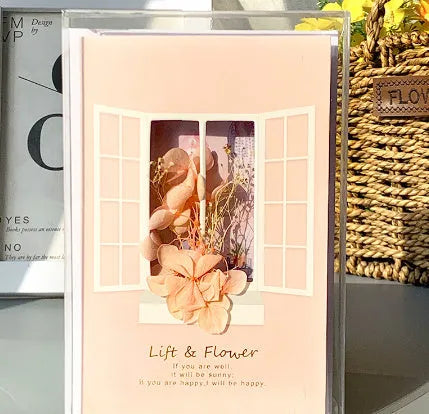 Handmade 3D butterfly-shaped greeting card with artificial flowers in a box, alongside its matching envelope.