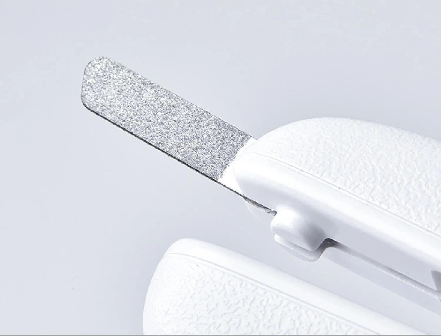 White LED pet nail clipper for cats and dogs with transparent anti-splash guard and file.
