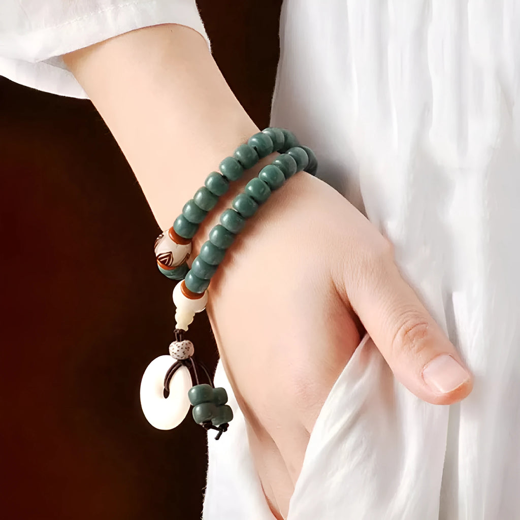 White jade and green sandalwood bodhi seed bracelet with double circle safety buckle and lotus design