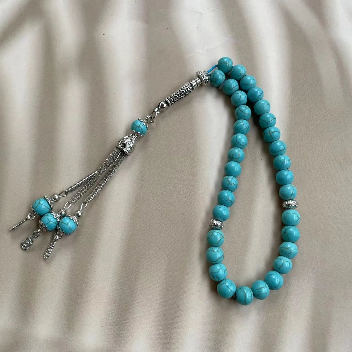 Handmade sky blue stone bead Muslim worship bracelet with 8mm beads on a white background
