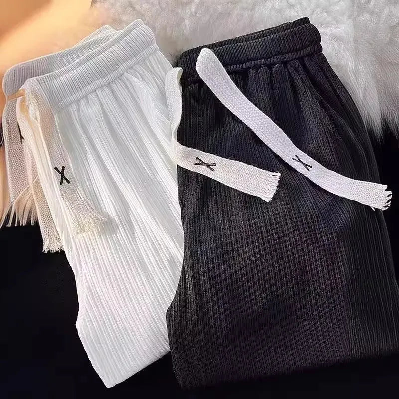 Men's loose straight-leg casual cotton trousers in black, shown flat.