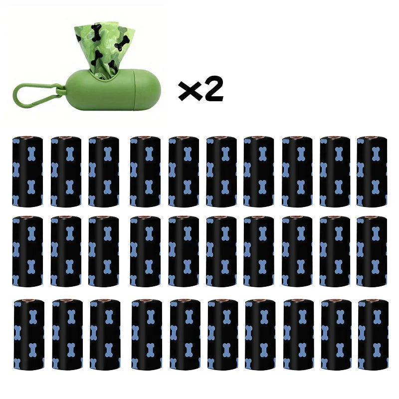 Biodegradable thickened dog poop bags in black and green on a roll with dispenser for pet waste cleanup.