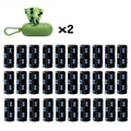 Biodegradable thickened dog poop bags in black and green on a roll with dispenser for pet waste cleanup.