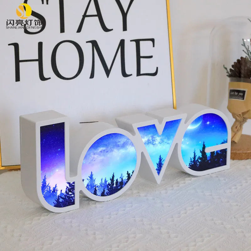 Rainbow style LED LOVE decorative table lamp with plastic shade on a table