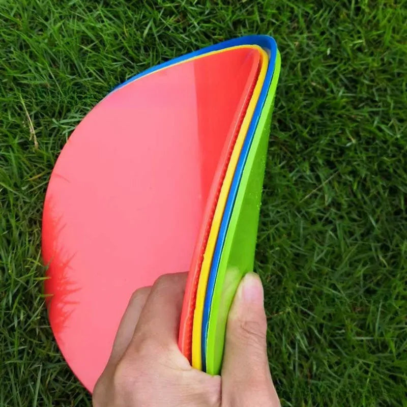 23cm diameter football training landmark pad in bright colours on grass field