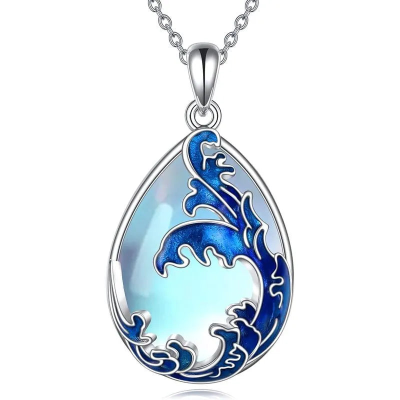 Close-up of a moonstone blue heart-shaped alloy pendant on a women's necklace.