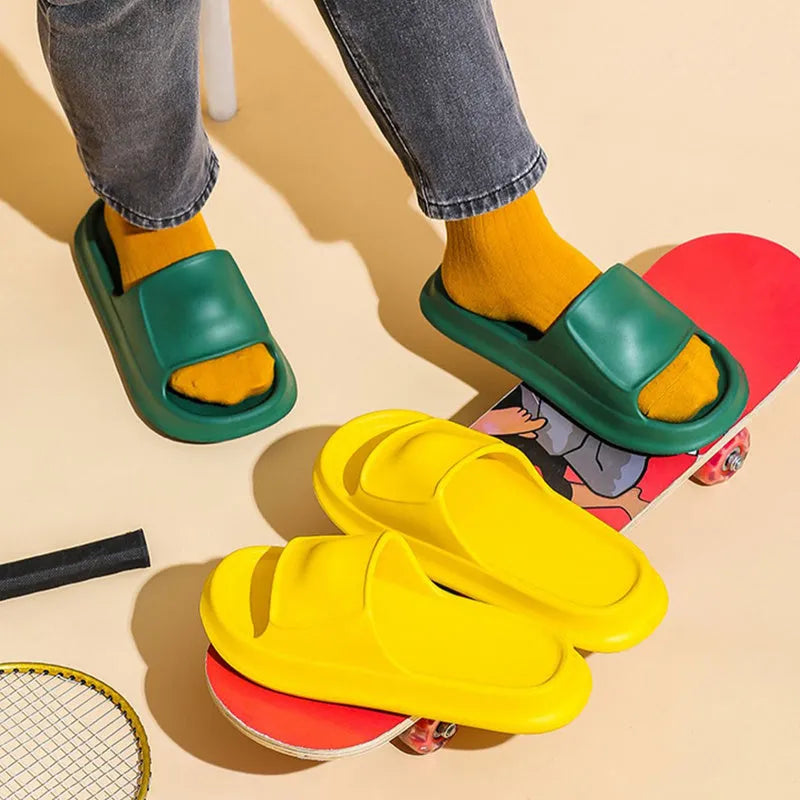 Pair of thick-soled EVA flip-flop slippers in a choice of seven colours, shown on a wet bathroom floor.