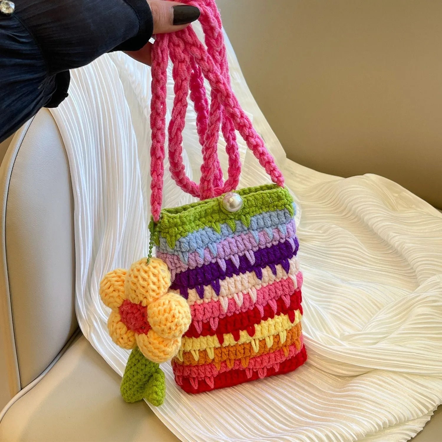 Colourful plush mobile phone shoulder bag with red and pink flower pendant decoration.