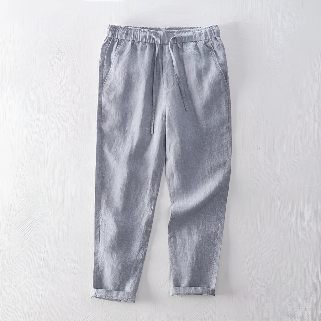 Men's straight-leg linen trousers in light gray shown laid flat.