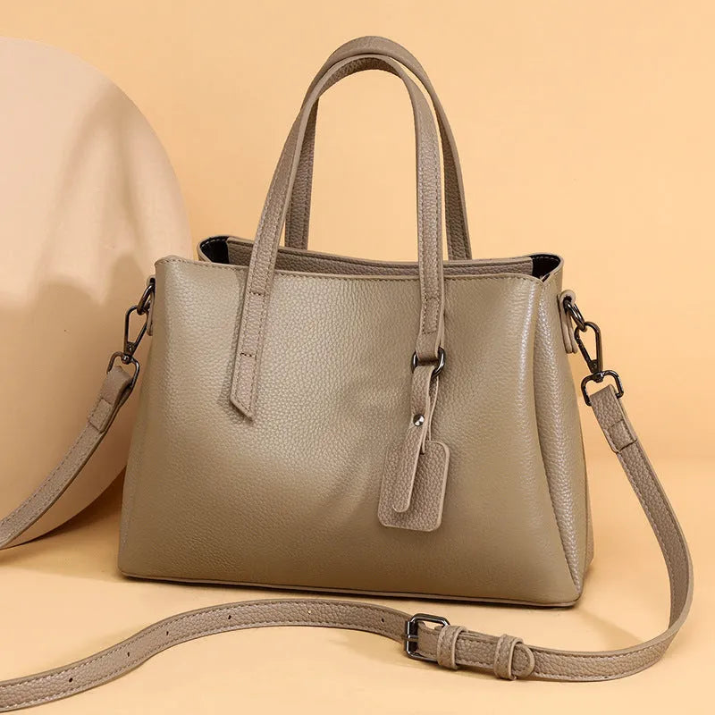 Genuine cowhide leather women's handbag in horizontal square shape with shoulder strap and organisational compartments