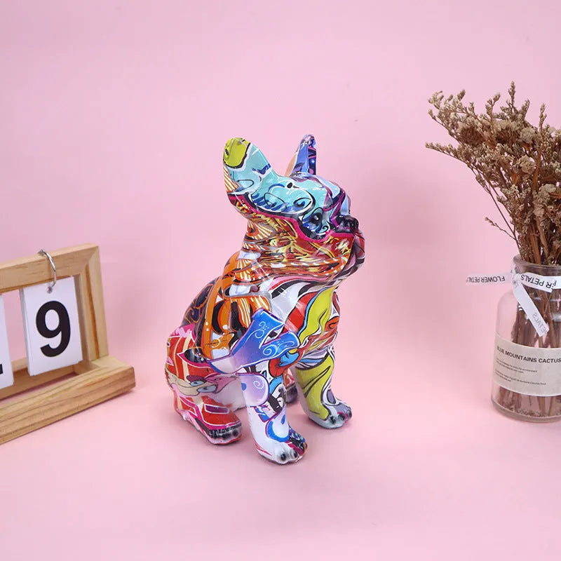 Graffiti-coloured resin French bulldog statue on a plain background.