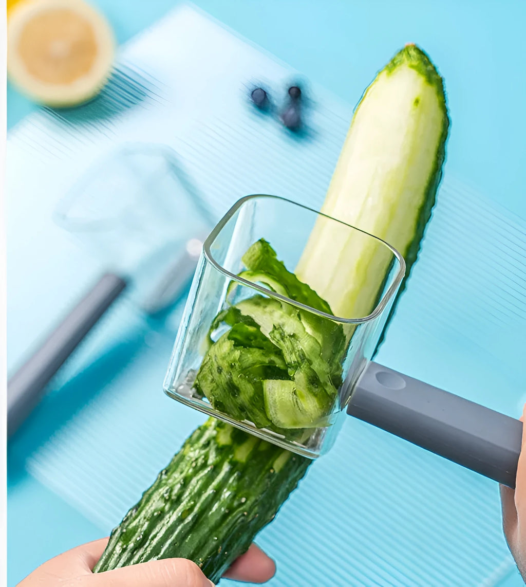 Green, grey, and red stainless steel kitchen peelers with plastic handles on a white background.