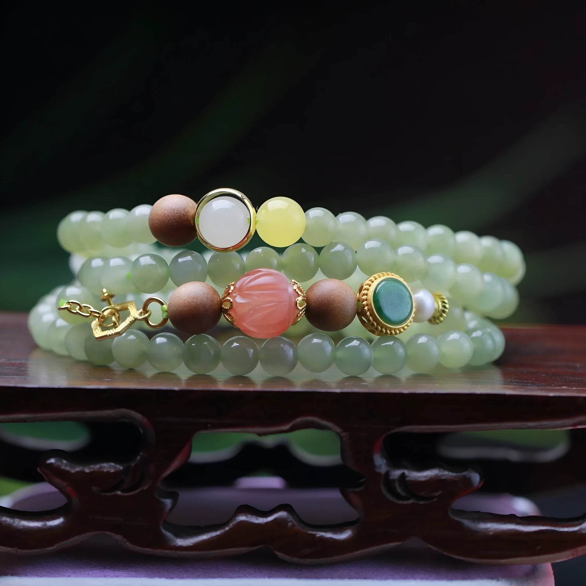 Hetian jade necklace with lotus beads, zodiac charm, and matching bracelet on white background