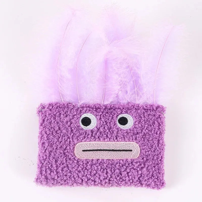 Colourful catnip plush toy with a funny big mouth explosion head shape on a blue background.