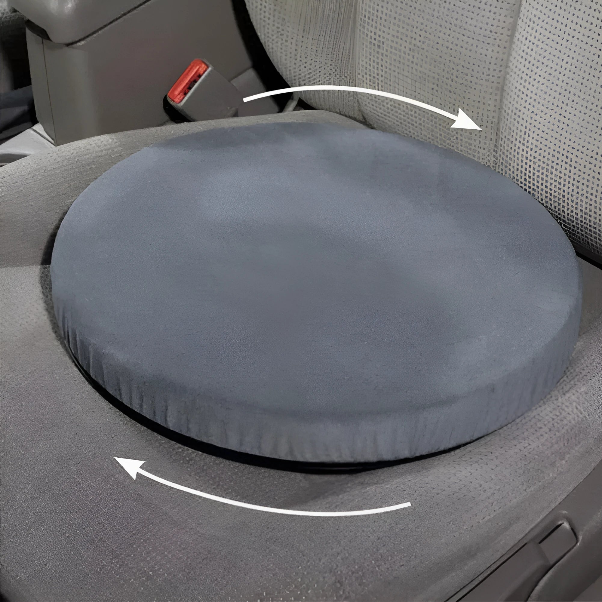 A grey rotating car seat cushion with a short plush cover, shown on a car seat.