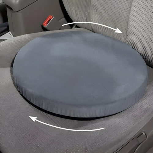 A grey rotating car seat cushion with a short plush cover, shown on a car seat.
