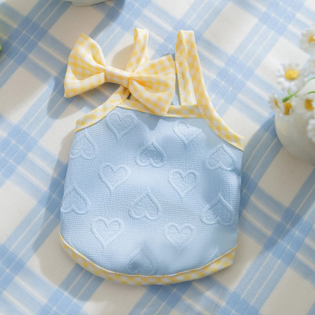 Small dog wearing heart bow suspenders vest in elastic polyester pet clothing