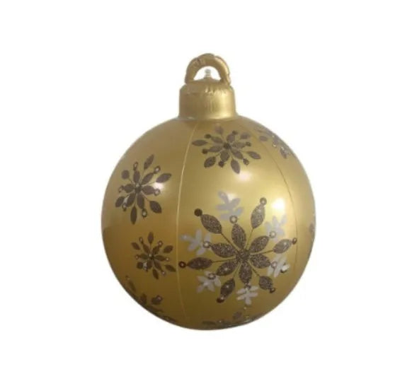Large red and white striped inflatable Christmas ball ornament hanging on an outdoor tree