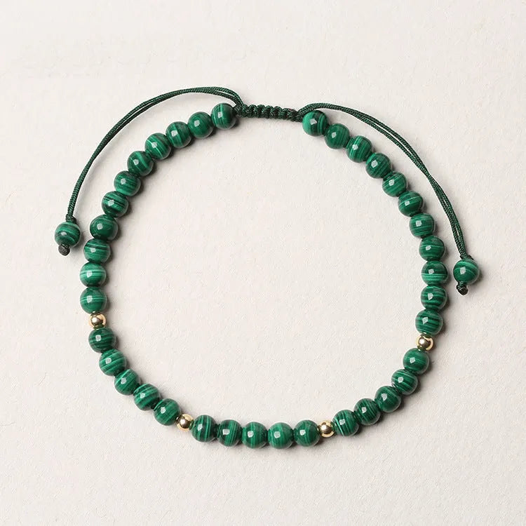 Green malachite stone bracelet with golden beads on woven strap, zodiac animal motif.