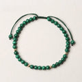 Green malachite stone bracelet with golden beads on woven strap, zodiac animal motif.